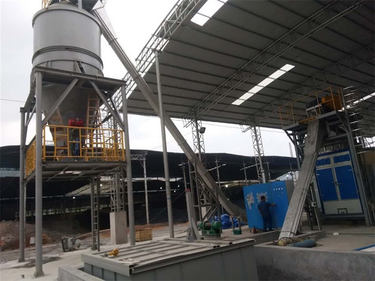 inclined scraper conveyor system moving dried sludge to green processing unit